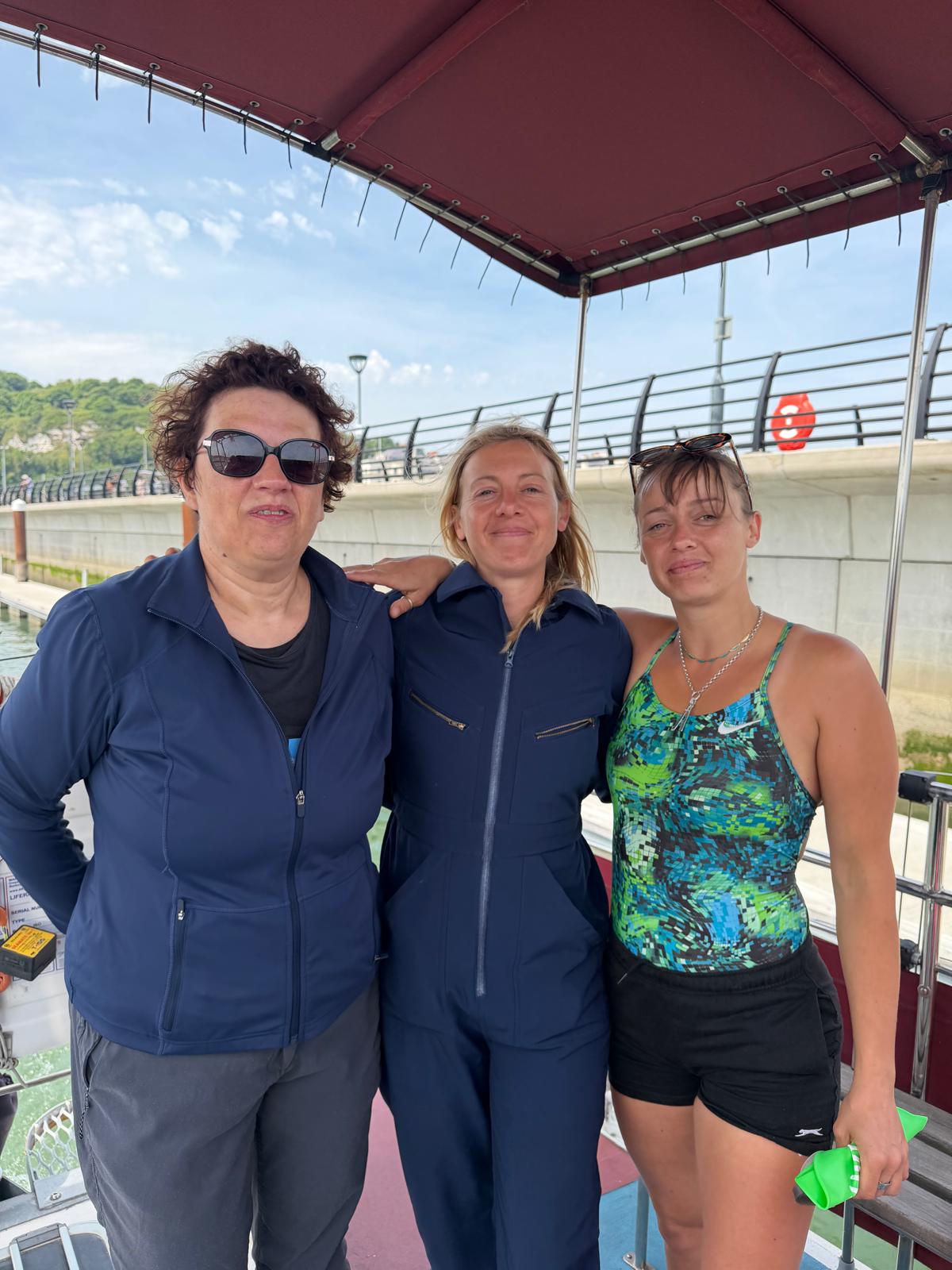 The Low Tiders standing together beside the English Channel